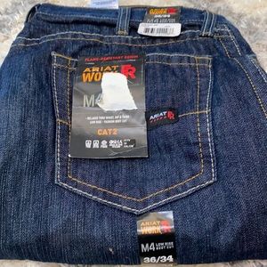 Ariat M4 FR work jeans. Low Rise/Boot cut. New with tags. Dark blue in color.